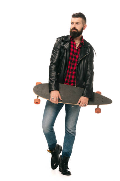 istock skateboarder in black leather jacket posing with longboard isolated on white 1144525353