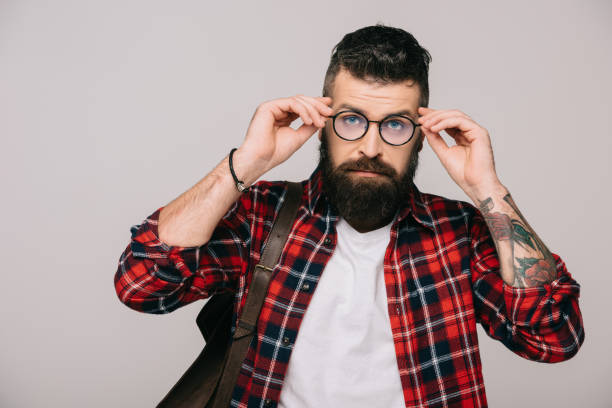 istock handsome bearded man in checkered shirt and eyeglasses, isolated on grey 1144525394