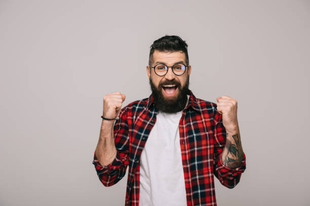 istock excited bearded man in checkered shirt, isolated on grey 1144525427