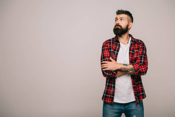 istock thoughtful bearded man in checkered shirt isolated on grey with copy space 1144525495