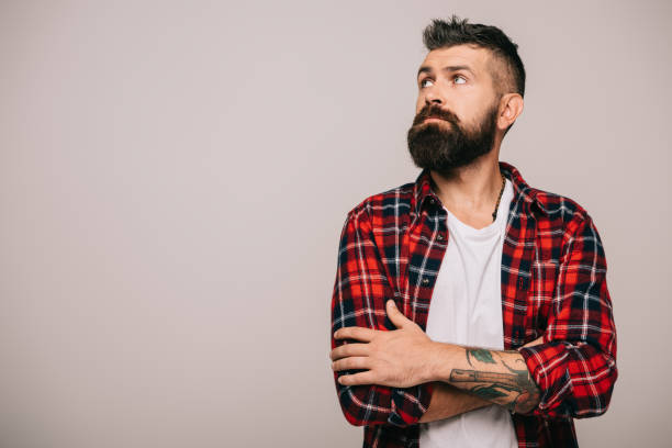 istock thoughtful bearded man in checkered shirt isolated on grey 1144525500