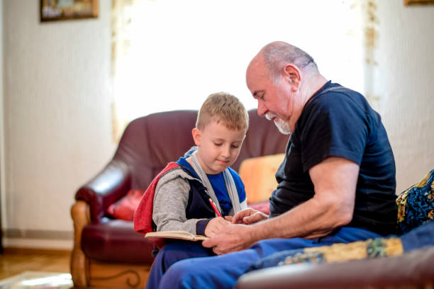istock Grandfather drawing with his grandson 1144527452