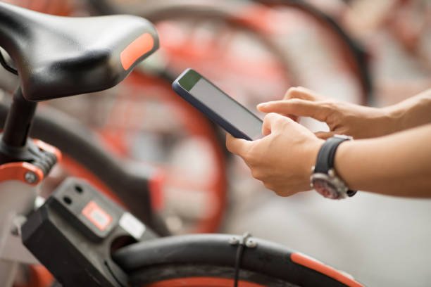istock Hands using smartphone scanning the QR code of shared bike in city 1144527652