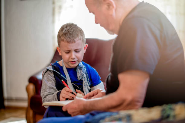 istock Grandfather and Grandson doing homework  together 1144527877