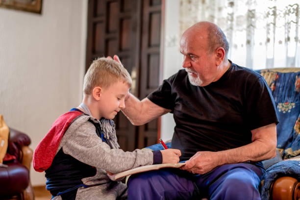 istock Grandfather and Grandson doing homework  together 1144528058