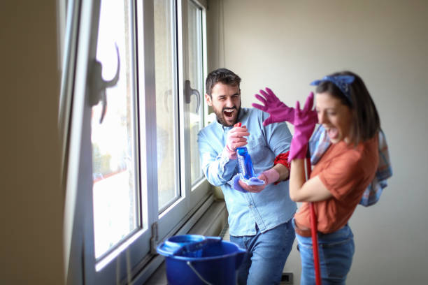 istock Beautiful young married couple cleaning apartment 1144528061