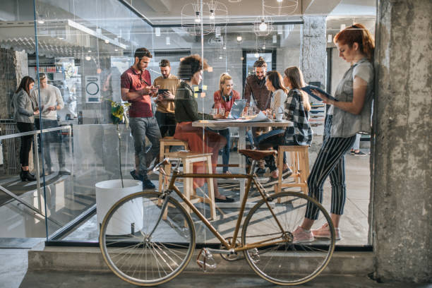 istock Large group of multi-tasking freelance workers at casual office. 1144528134