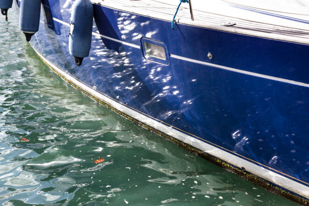 hull of a motor boat floating in the berth of the port of malaga, spain - rowboat nautical vessel small motorboat imagens e fotografias de stock