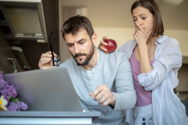 istock Focused  couple paying bills online on laptop 1144531129
