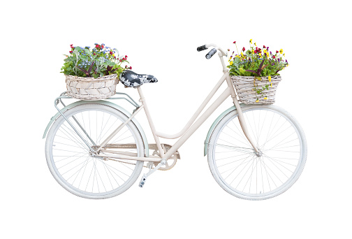 Retro bicycle with floral baskets isolated