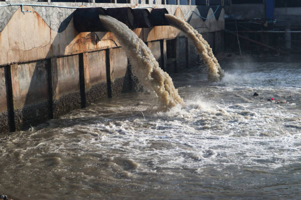 istock Waste water discharge pipe into canal and sea 1144533154