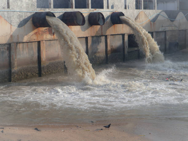 istock Waste water discharge pipe into canal and sea 1144533311