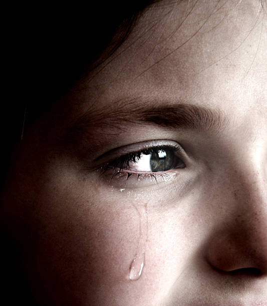 istock Crying girl with tear on cheek 114453343