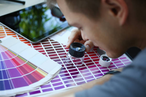istock Male serviceman hold in hand magnifying glass making colour test 1144535129