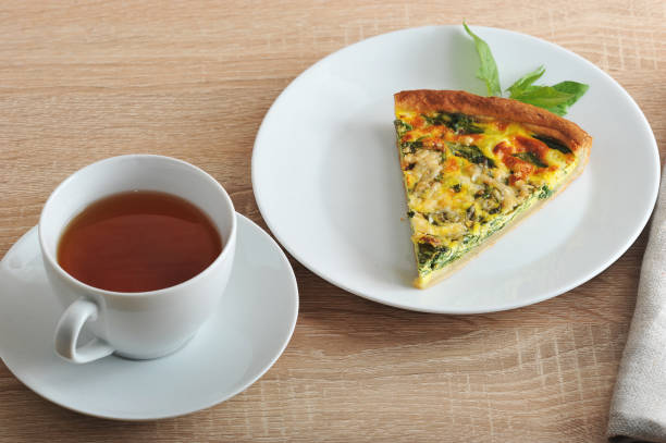 istock A portion of the pie with spinach and a cup of tea. 1144536118