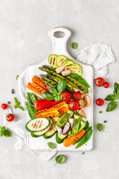 istock Grilled vegetables served on a wooden board, view from above 1144537512