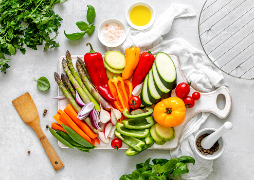 Fresh cut vegetables on a kitchen table cut and prepared for grilling, view from above