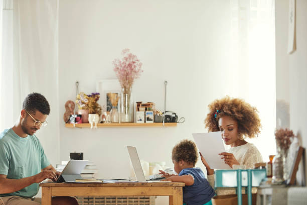 istock Mother and father working while sitting with son 1144539382