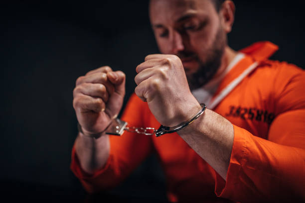 istock Male prisoner wearing handcuffs 1144541972