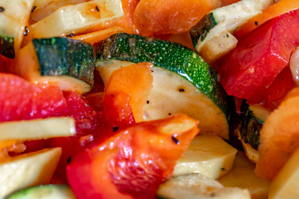 istock Raw fresh vegetables cut for further processing, mixed and topped with an oily spice mixture. 1144544602