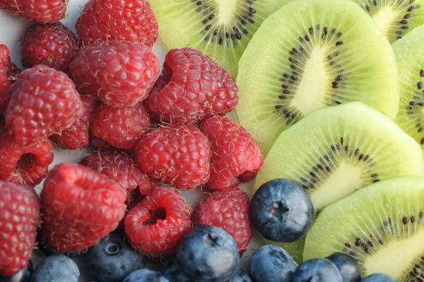 istock Raspberries, blueberries and kiwi slices close-up. 1144545653