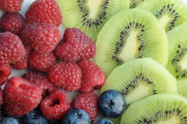 istock Raspberries, blueberries and kiwi slices close-up. 1144545657