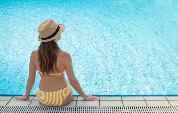 istock Young woman relaxing in swimming pool 1144547411