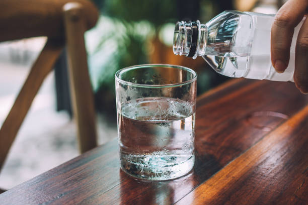 istock People pouring water into the glass 1144547561