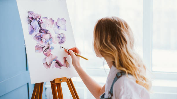 artist lifestyle painting hobby talent creating Artist lifestyle. Painting hobby. Imagination and inspiration. Talented woman creating beautiful watercolor floral design. conspiracy photos stock pictures, royalty-free photos & images