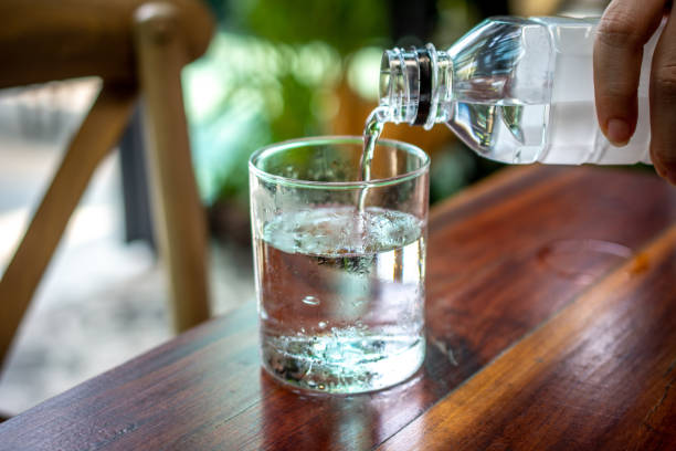 istock People pouring water into the glass 1144548080