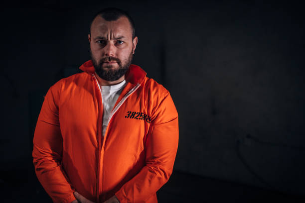 istock Convict in orange jumpsuit 1144550985