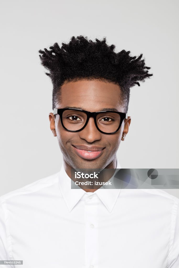 Smart young afro american businessman Close up portrait of smart young afro american businessman in nerd eyeglasses on gray background. African Ethnicity Stock Photo