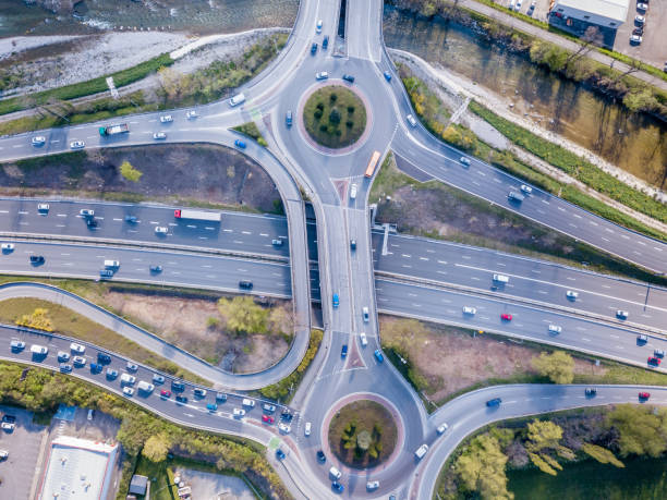 istock Highway interchange junction with traffic aerial top down view photography from drone with vehicles driving on freeway, roundabout and ramp lanes, transportation from above 1144553335