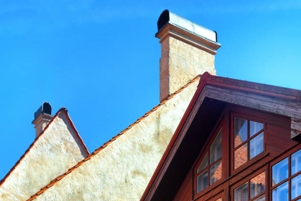 istock Tiled red gabled roofs with pipes 1144557295