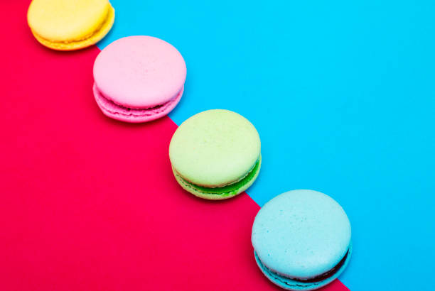 istock Assortment of macarons on red - blue background 1144557488