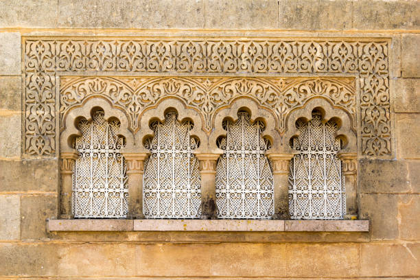 Traditional Moroccan window in Moorish style of architecture and ornament on stone wall