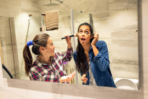 istock two friends putting make up and having fun 1144557855