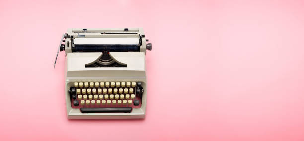 istock Top view of a 70s typewriter isolated on pink background. 1144559305