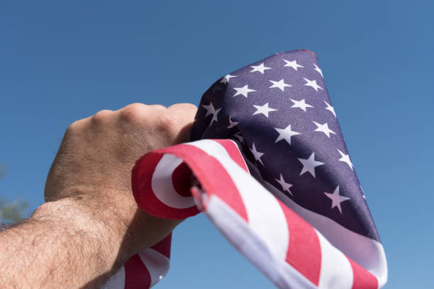 istock A man has the flag of US in his hand 1144564405