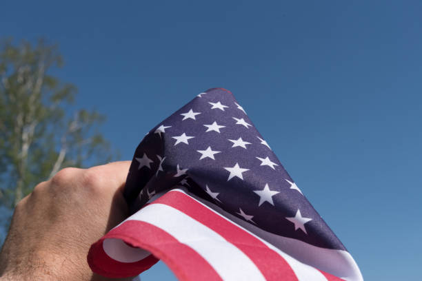 istock A man has the flag of US in his hand 1144564539