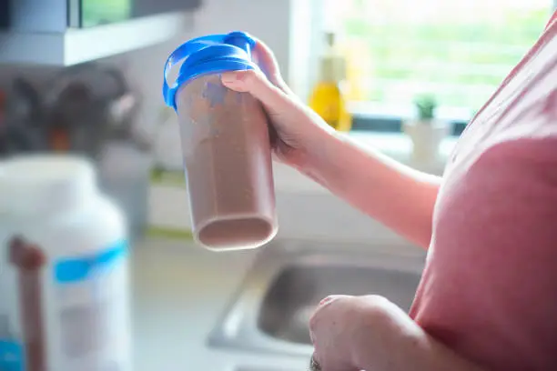 Taking protein drink in shaker to mix up the ingredients