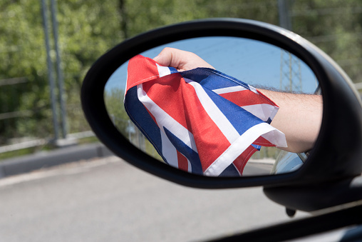 Flag of Great Britain visible in the mirror of a car