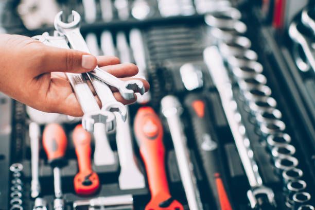tool hardware store hand spanner auto repair kit Tool hardware store. Closeup of male hand holding wrenches and spanners. Auto repair kit in toolbox. Repairman instruments set. car instruments stock pictures, royalty-free photos & images