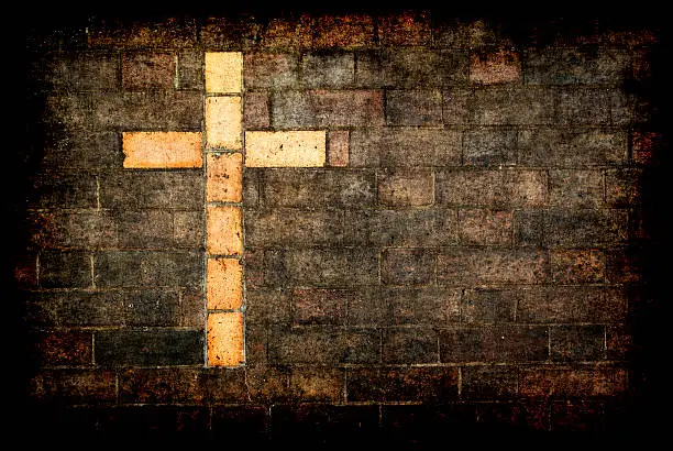 Photo of cross of christ built into a brick wall