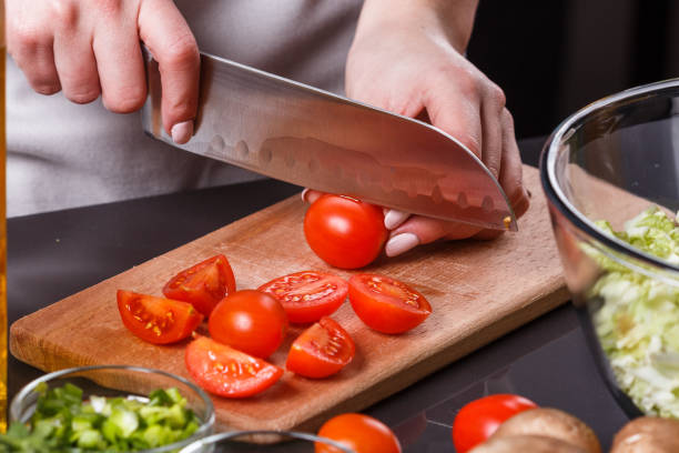 istock young woman in a gray apron cherry tomatoes 1144571526