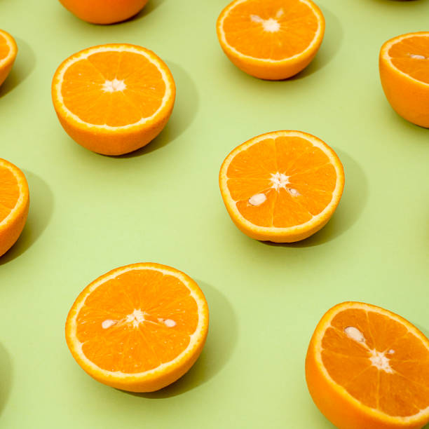 istock Orange juicy oranges split in half on green 1144574140