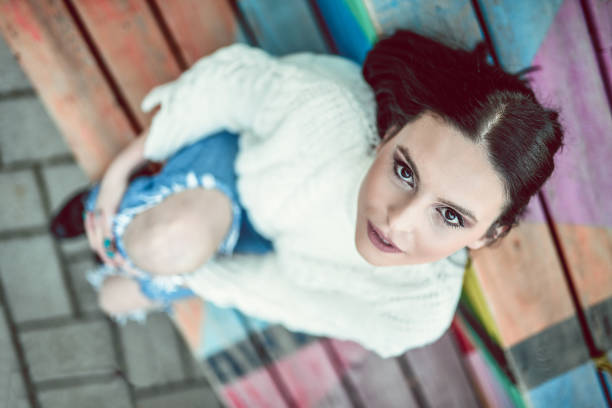 Cute Female Sitting On A Bench In The Park