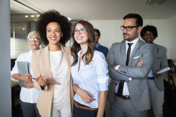 istock Successful company with happy workers in office 1144575779
