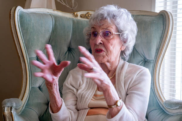 istock 100-Year Old Woman Having a Cheerful Conversation in Her Home 1144575954