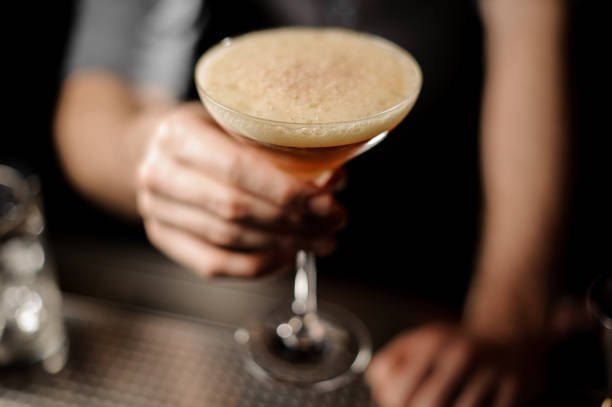 istock Bartender serving cocktail with a whipped cream and grated nutmeg 1144576223